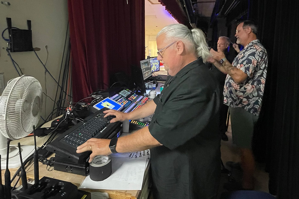 sound engineer manning the board during a contemporary worship service at EMC